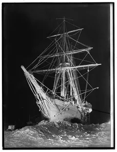Frank Hurley, A spectre ship looming stark and white against the darkness of the polar night